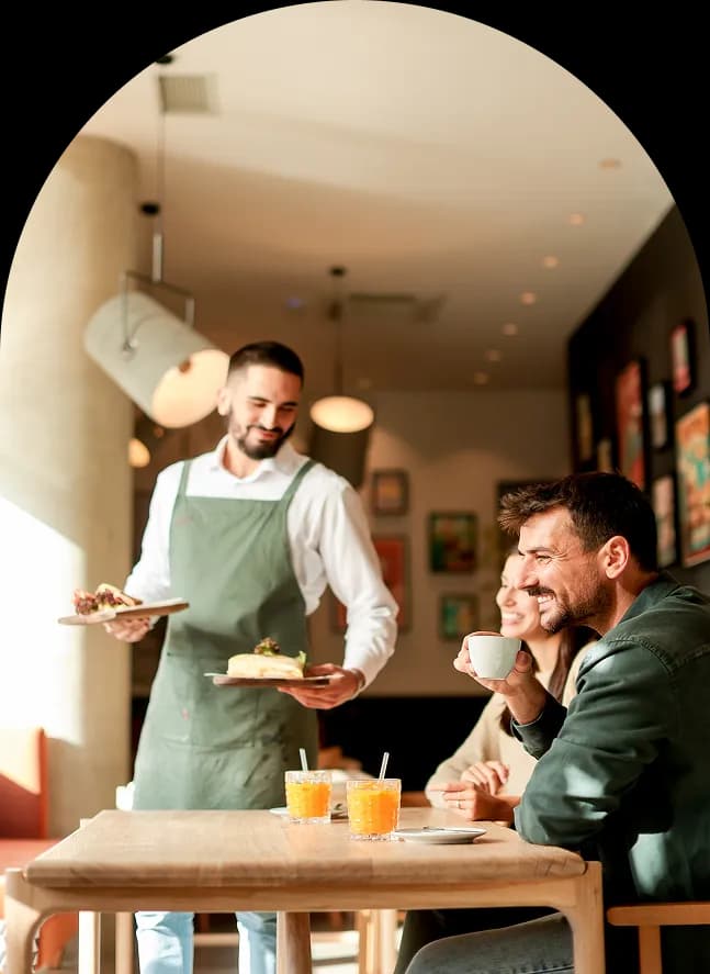 Waiter serving guests in a restaurant